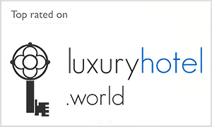 Logo top rated on luxury hotel world Top rated by Luxuryhotel.world
